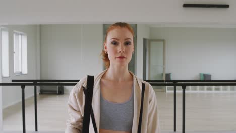 caucasian female ballet dancer smiling and looking at camera