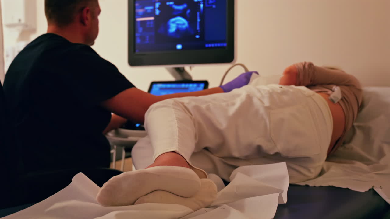 Pregnant woman undergoing an ultrasonography at a doctor's office