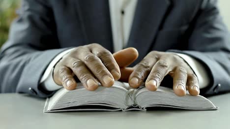 black man praying to god with bible in hands caribbean man praying with background with people stock video stock footage