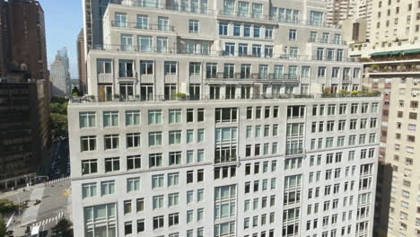 aerial view around the facade of a luxury condo in central park, sunny new york