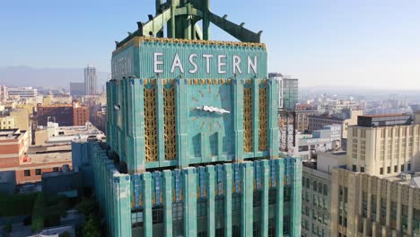 Vista-Aérea-Of-The-Historic-Eastern-Building-In-Downtown-Los-Angeles-With-Clock-And-Downtown-City-Skyline-Behind-3