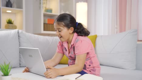 Girl-child-joyfully-embracing-laptop.