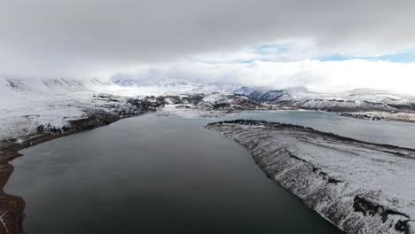 Snowy Caviahue lake and dramatic winter clouds over Andes mountains in Argentina