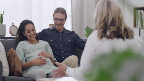 interracial pregnant couple talking to a therapist