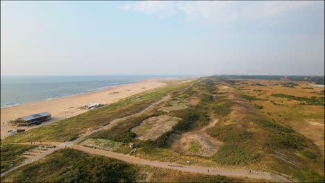 Aerial-view-over-grassy-area-by-Monster-Beach,-Netherlands