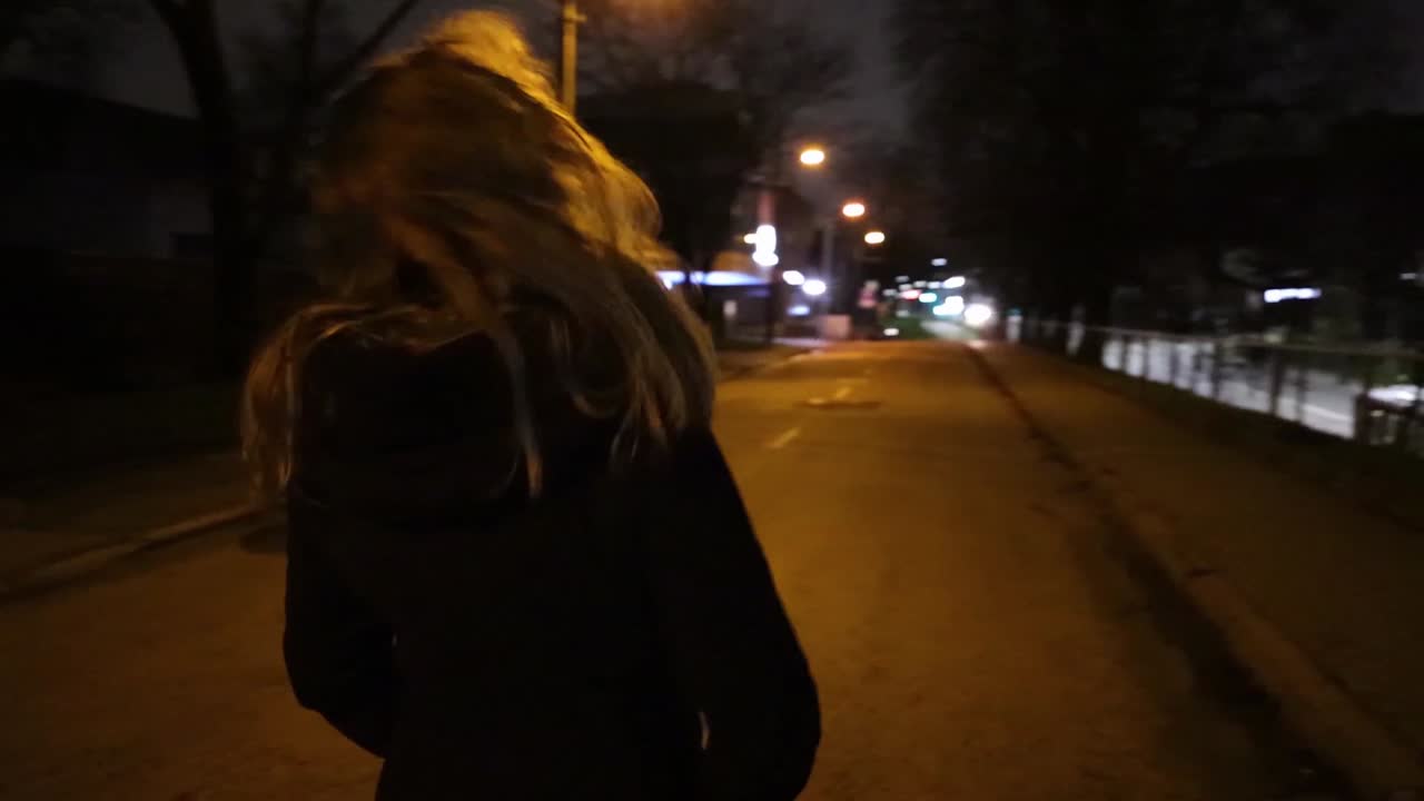 Girl taking a walk in the city at night time time slow motion