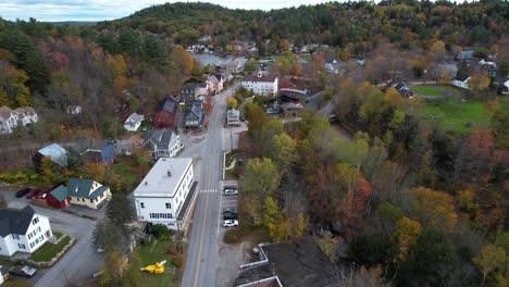 aerial view of lake sunapee neighborhood, colorful autumn foliage, buildings and road, drone shot