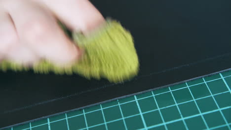 person hand moves yellow wet towel on insoluble line closeup