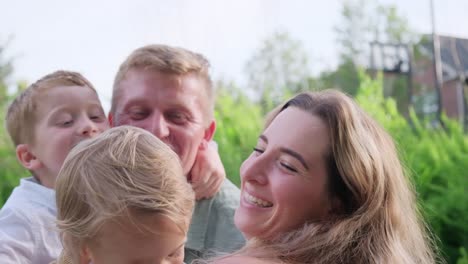 the video shows a loving couple joyfully embracing their kids this heartwarming video showcases a couple joyfully holding their children the woman lovingly cradles them highlighting family connections