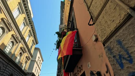 colorful flag waving in a narrow street