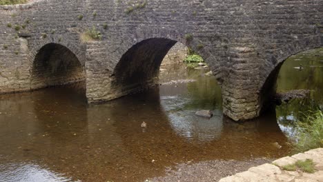 mid shot of stone bridge at wetton mill looking east