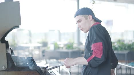 chef grilling burgers on outdoor grill