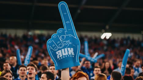 exciting moments in a stadium full of energetic fans cheering with vibrant foam fingers, creating an unforgettable atmosphere of passion and support for their team