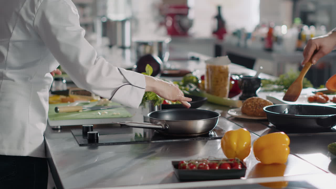 Young woman cooking food recipe with garlic clove on kitchen stove