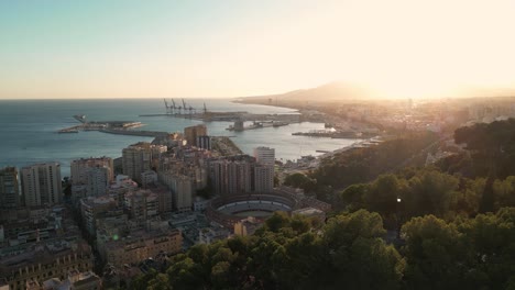 sunlit malaga skyline with la malagueta bullring, harbor, and the mediterranean coast. spain