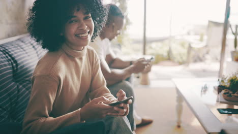 a couple using their cellphones while sitting