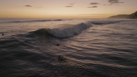 aerial drone view of surfers at sunset el zonte el salvador