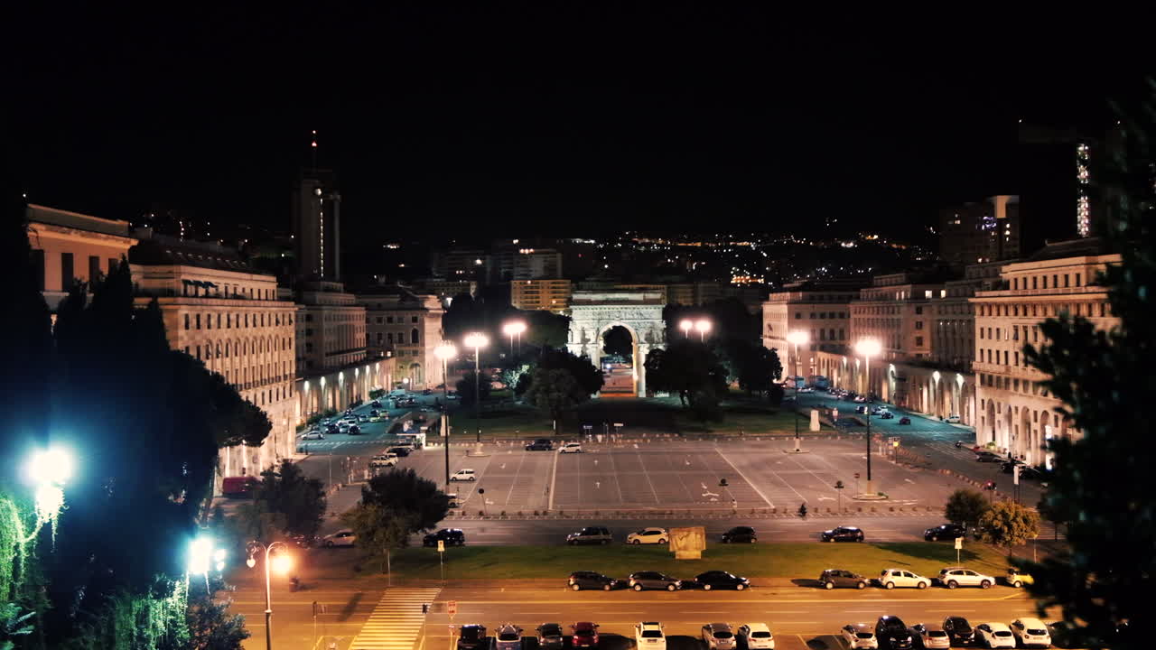Beautiful night view of Piazza della Vittoria in Genoa, Italy, with the Arco della Vittoria illuminated by city lights