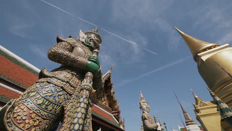 giant statues at the grand palace in bangkok, thailand