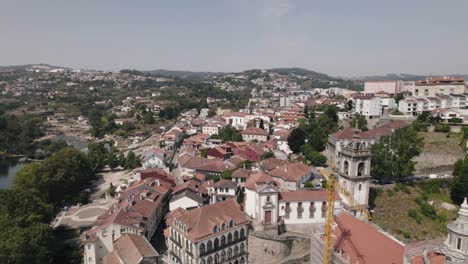 majestic rooftops of amarante town in portugal, aerial orbit view