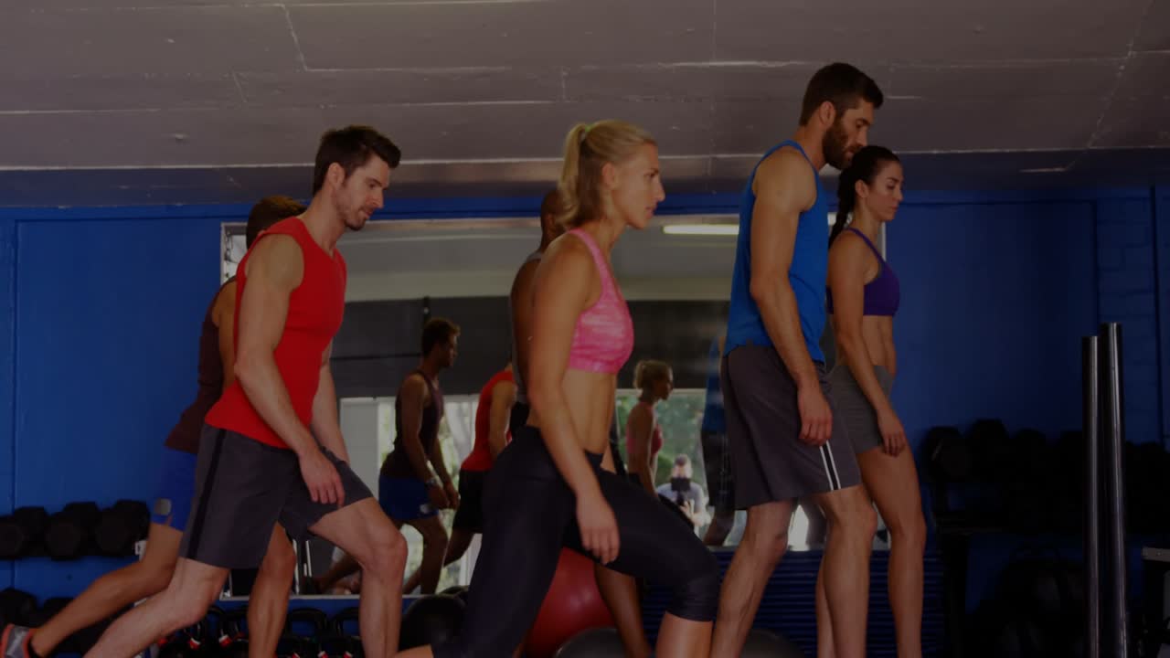 Lead cueing, six exercisers lunging through range on turf, waveform syncing to rhythm for fitness