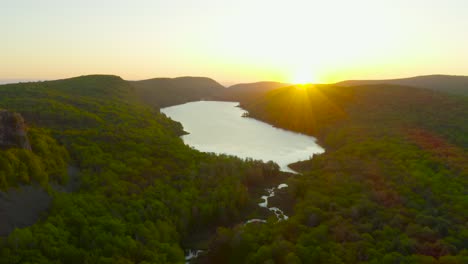 aerial descent during sunrise over lake of the clouds in michigan's porcupine mountains state park