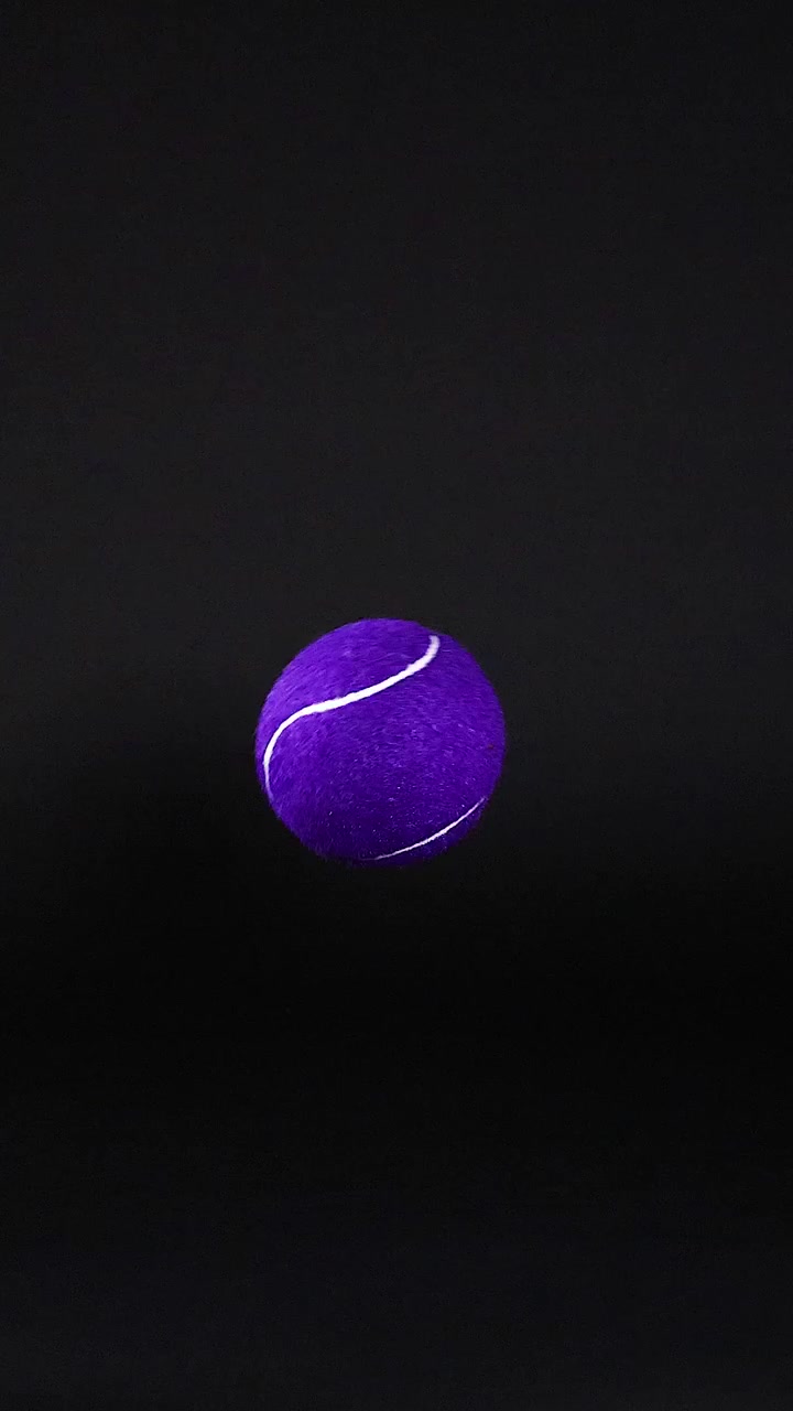 A purple tennis ball moves across frames