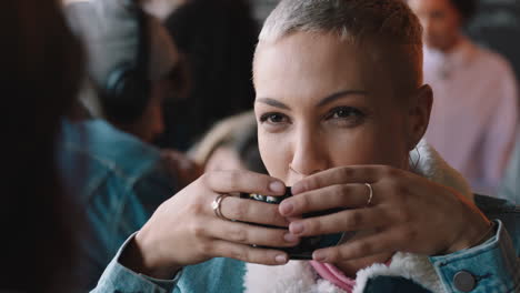 beautiful woman chatting with friend in cafe drinking coffee socializing enjoying conversation hanging out in busy restaurant