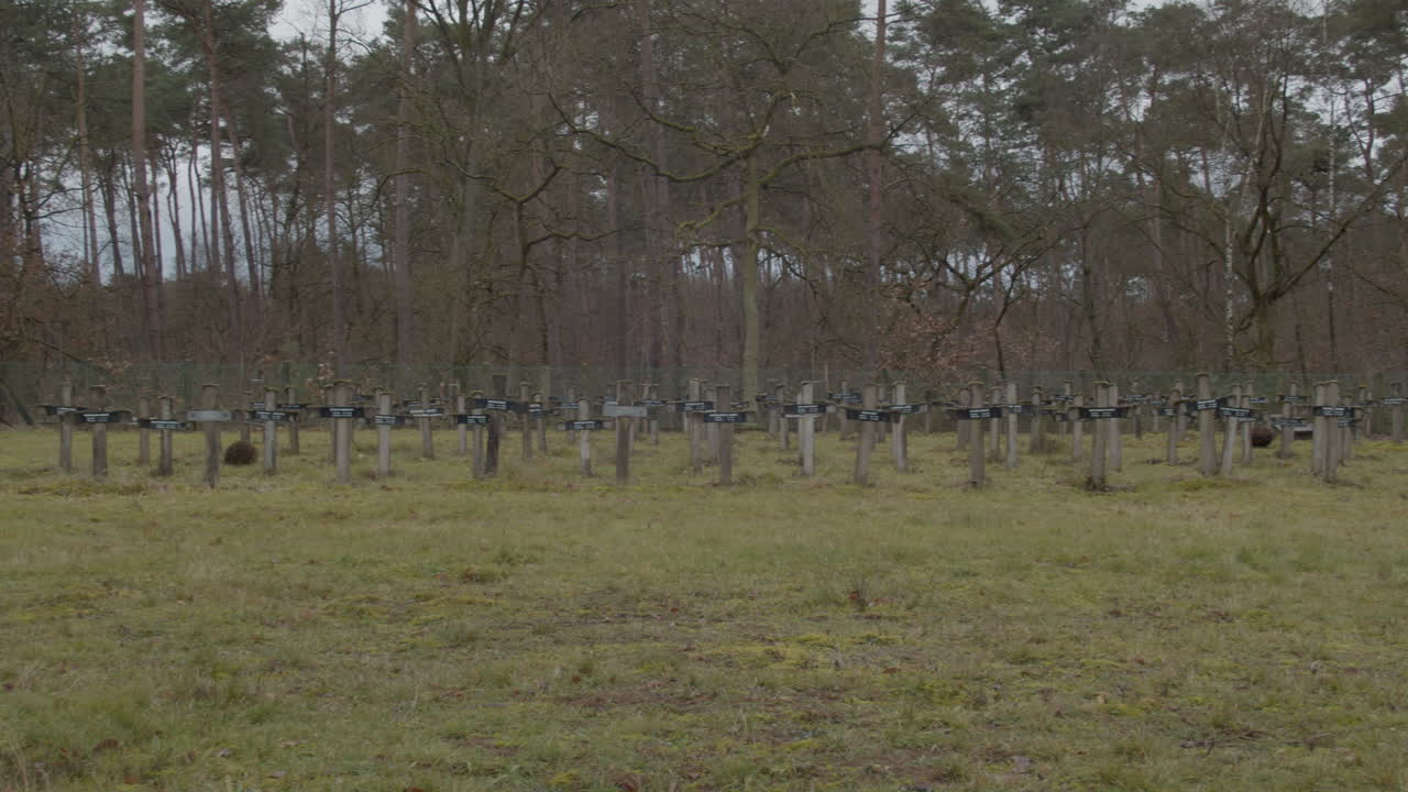Pan over distant gravestones at abandoned graveyard