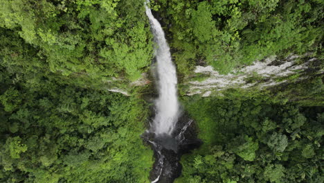 stunning falls cascade down cliff with lush vegetation into toro river canyon, costa rica