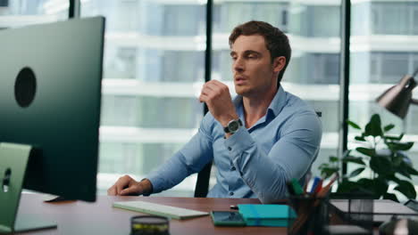 portrait worried office worker sitting at desk . tired manager working on pc.