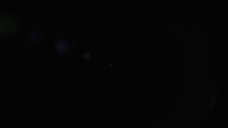 a close-up of the lens of a video camera. the light source illuminates the lenses, then goes into darkness
