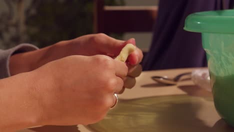 young woman hands kneading dough to prepare small pizza, esfiha