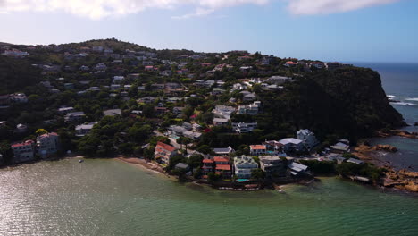 Aerial-arc-at-Knysna-Heads-revealing-scenic-setting-of-houses,-Garden-Route