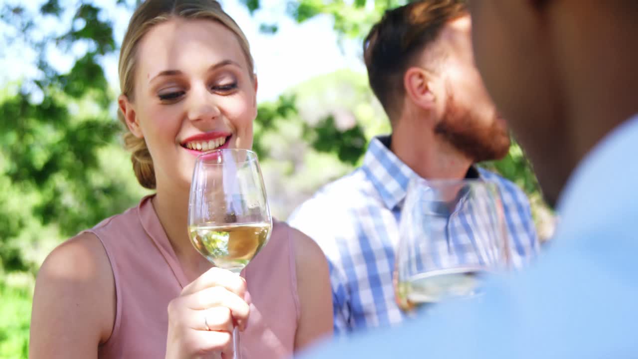 Friends toasting glasses of wine at restaurant