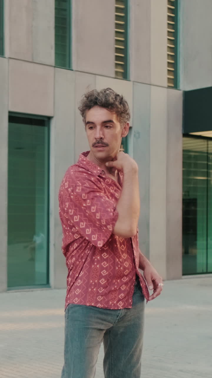 Stylish Man with Mustache Posing in Front of Modern Urban Building