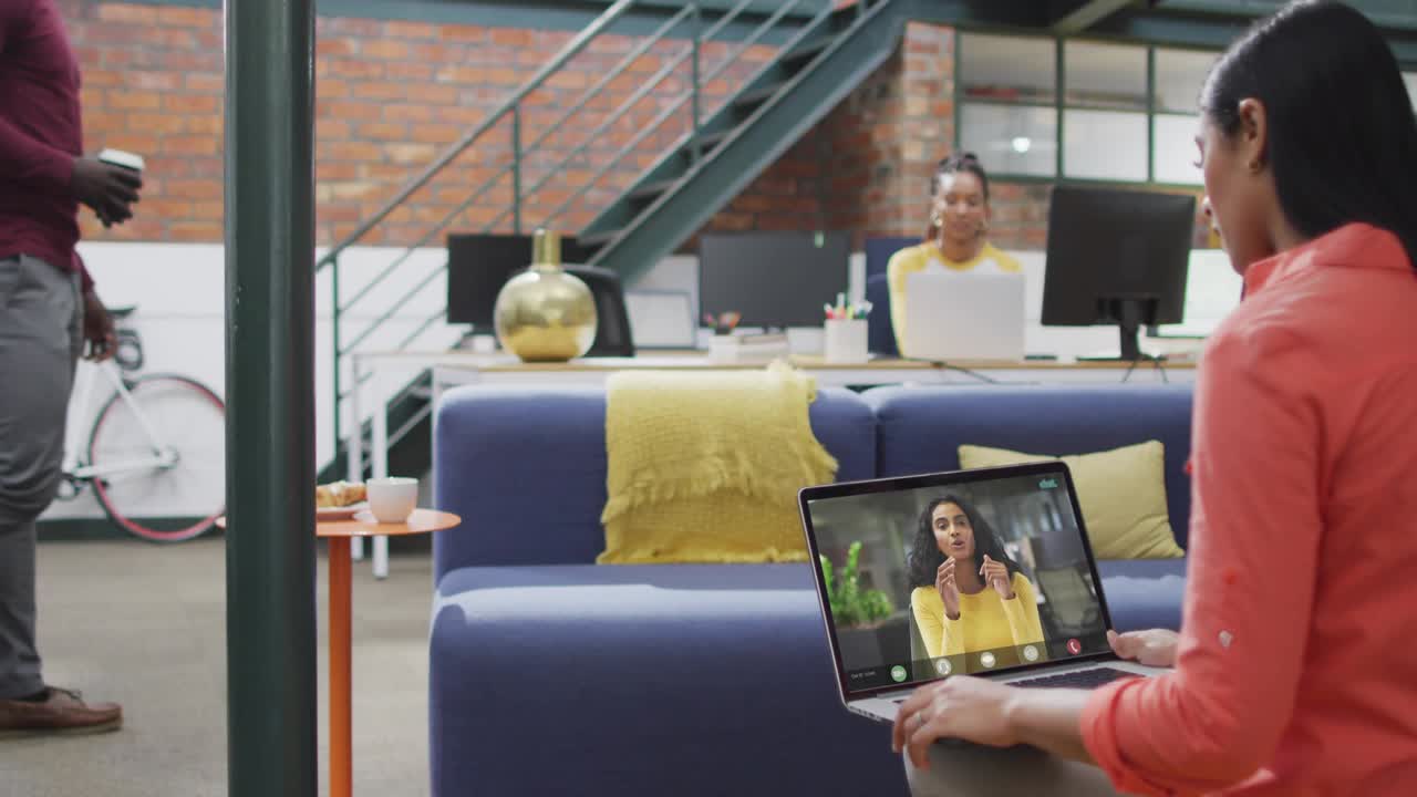 Woman holding laptop man walking sparking social alerts rising around screen settling for marketing