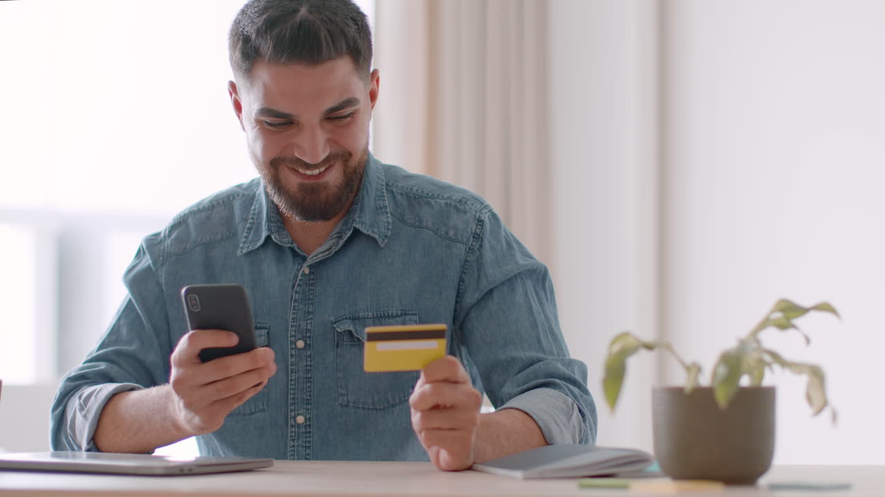 Man Using Smartphone and Credit Card for Online Shopping