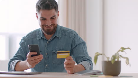man using smartphone and credit card for online shopping