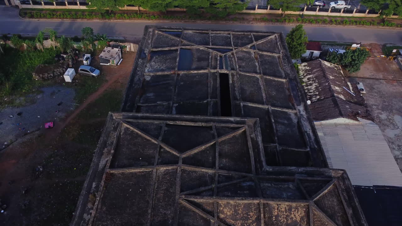 Jib up of an old rooftop of a rundown building in a neighborhood under redevelopment in Abuja, Nigeria