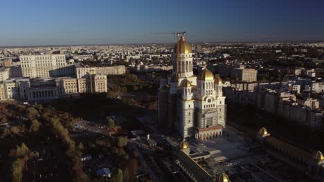 high altitude aerial orbit shot around cathedral of the salvation of the nation, bucharest, romania, autumn sunset