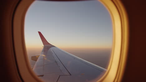 pov moving forward through the airplane window in a beautiful sunset during the flight
