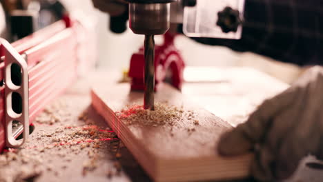 Wood,-closeup-and-drill-with-person-in-workshop