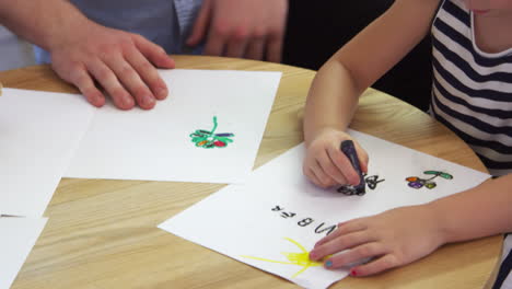 pupil drawing with crayon in montessori school class