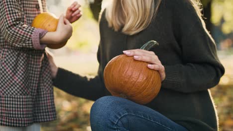 handheld view of mother and daughter embracing in forest path