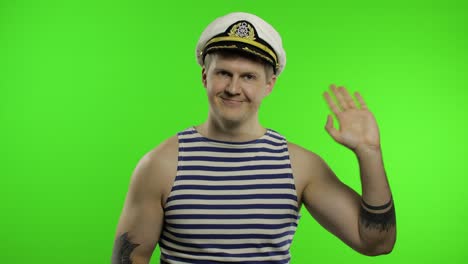 young sailor man waving hands. seaman guy in sailor's vest. chroma key