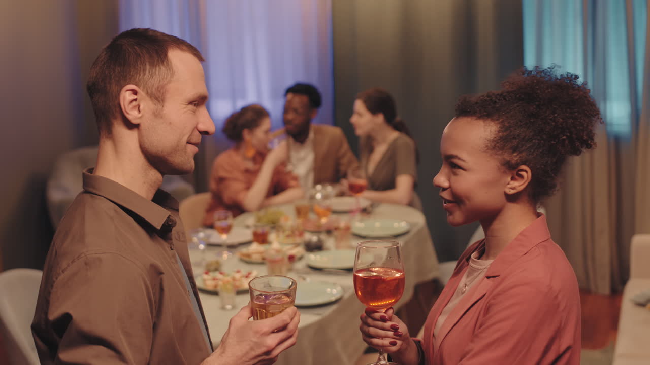 Multiethnic Couple Flirting at Friends Dinner Party