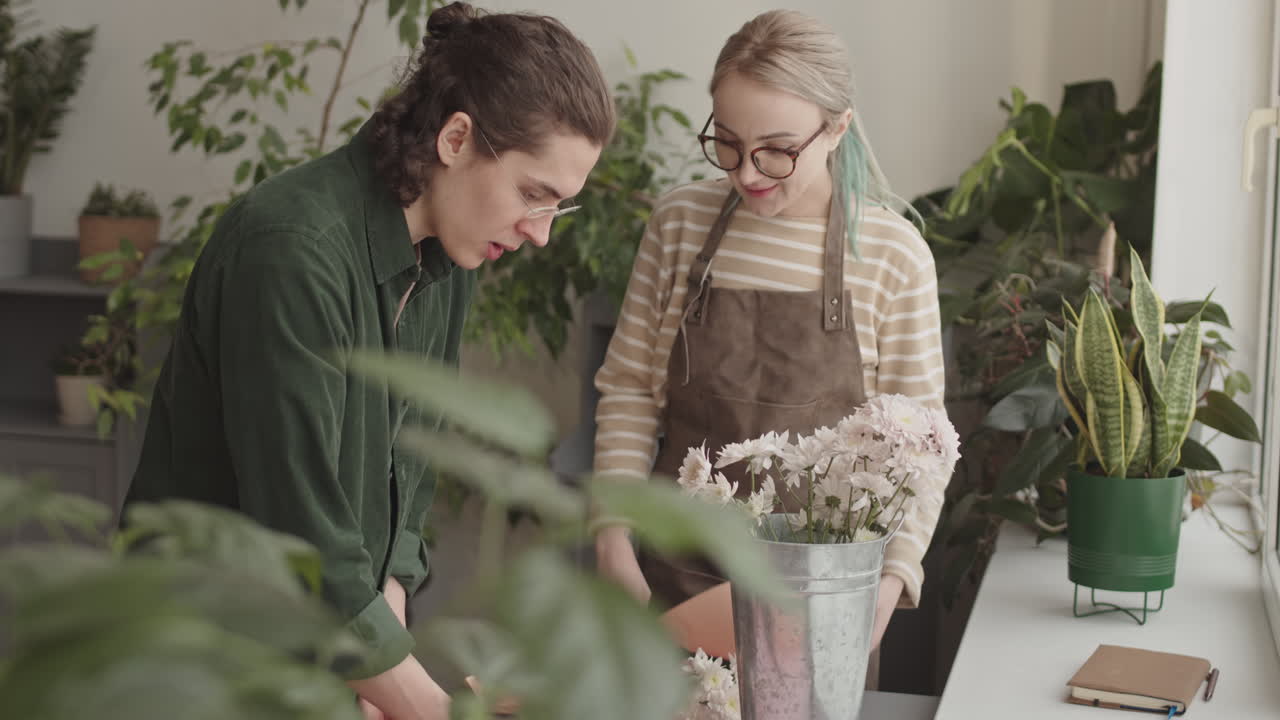 Florists collaborating on a flower arrangement