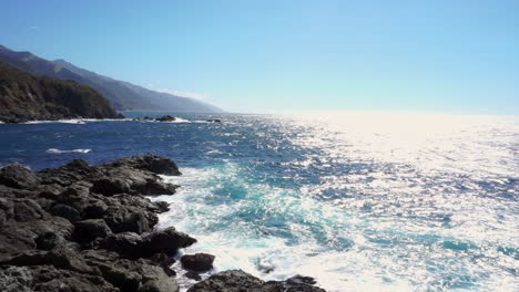 pacific ocean waves crashing against the coastline in big sur, california