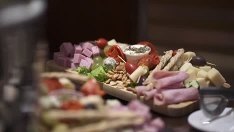 Elegant-charcuterie-platter-featuring-a-variety-of-cheeses-and-other-starters,-perfect-for-business-dinners,-weddings,-or-any-special-event---Panning-shot